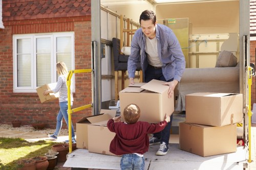 Moving team loading items with safety equipment and protective care