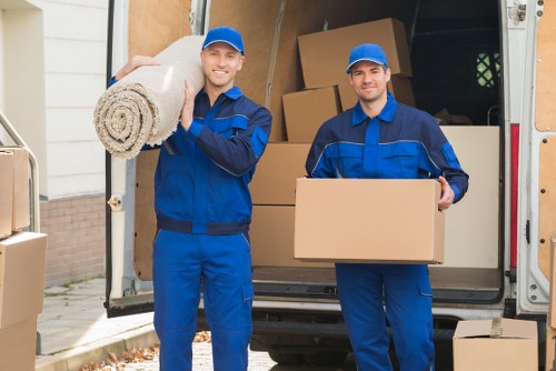 Staff using moving equipment and PPE during a load-in