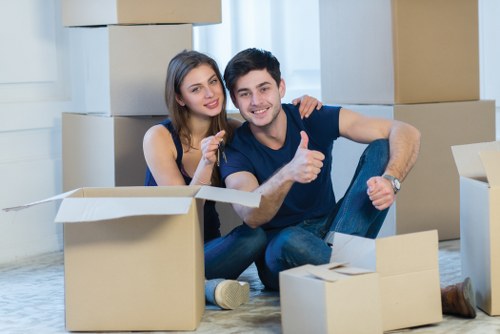 Professional movers handling desks and IT equipment during an office move