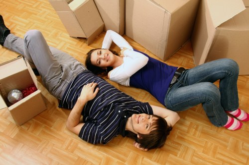 Professional movers protecting sofas and tables during Harringay furniture removals