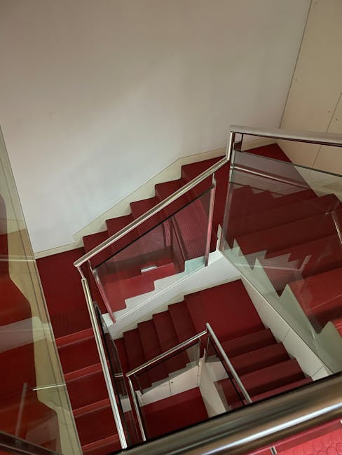 A bright indoor space in a residential property showing a team from Man and a Van Harringay engaged in home relocation activities. Several cardboard moving boxes, some sealed with packing tape and oth